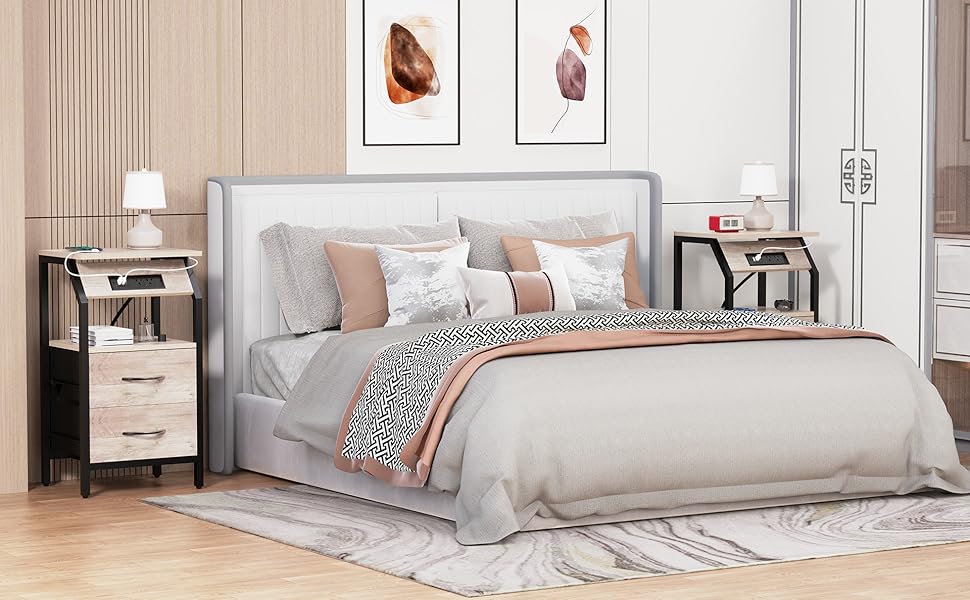 A neatly made bed beside a nightstand with a dimmed lamp and a cup, arranged for a restful evening
